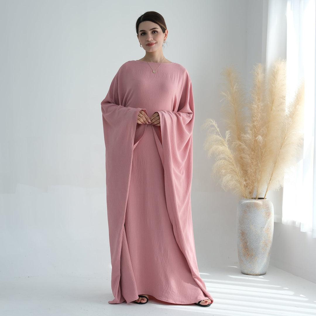 Get trendy with Naimah Textured Butterfly Abaya - Pink Coral -  available at Voilee NY. Grab yours for $54.90 today!