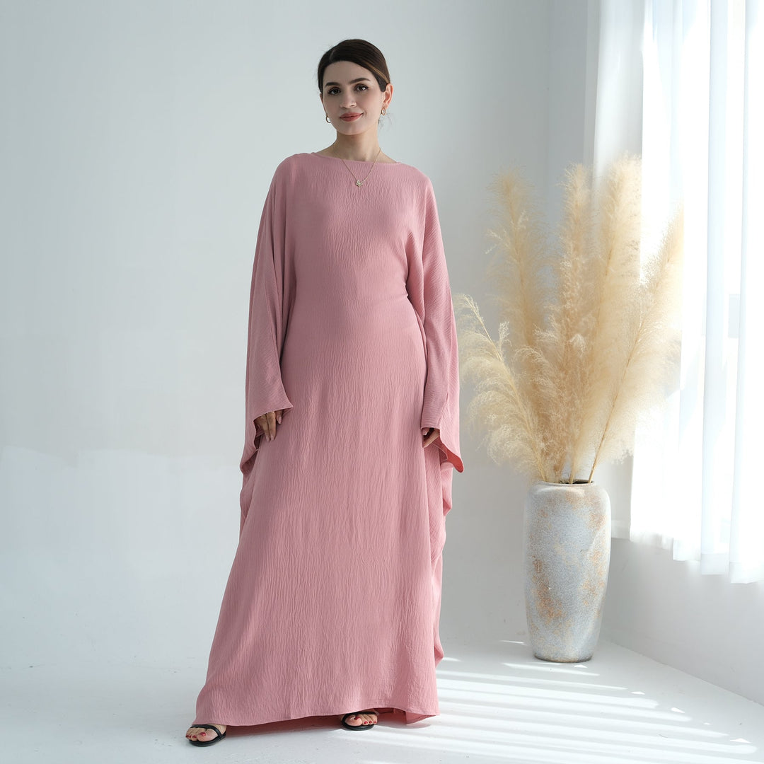 Get trendy with Naimah Textured Butterfly Abaya - Pink Coral -  available at Voilee NY. Grab yours for $54.90 today!