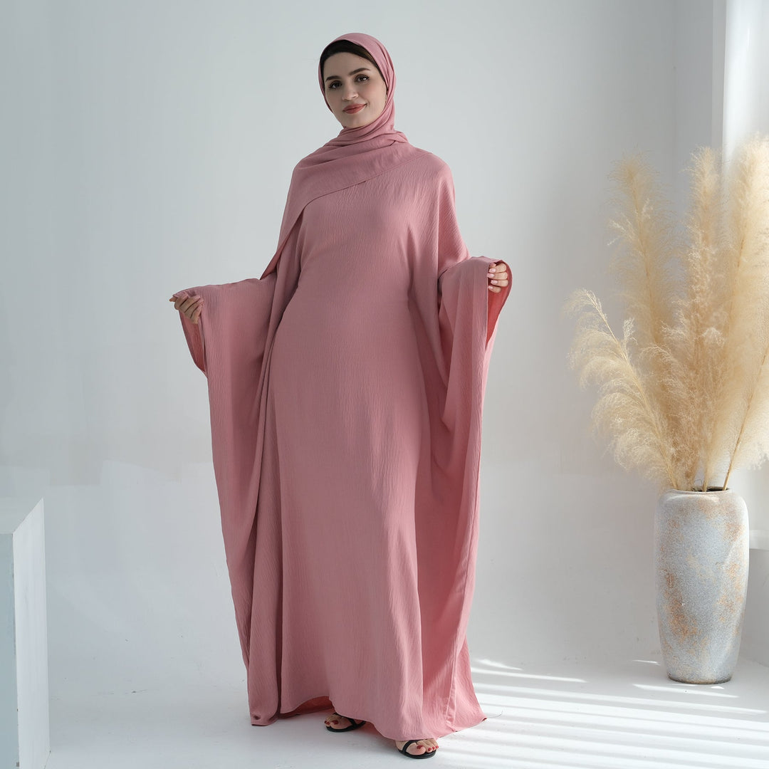 Get trendy with Naimah Textured Butterfly Abaya - Pink Coral -  available at Voilee NY. Grab yours for $54.90 today!