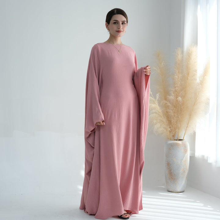 Get trendy with Naimah Textured Butterfly Abaya - Pink Coral -  available at Voilee NY. Grab yours for $54.90 today!