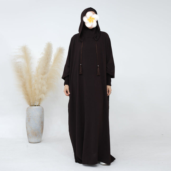 Get trendy with Rubina Double Hoodie Abaya - Coffee - Dresses available at Voilee NY. Grab yours for $59.99 today!