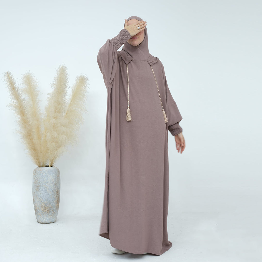 Get trendy with Rubina Double Hoodie Abaya - Latte - Dresses available at Voilee NY. Grab yours for $59.99 today!