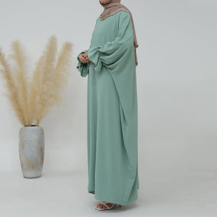 Get trendy with Dimma Bell Cuffs Abaya - Mint - Dresses available at Voilee NY. Grab yours for $54.90 today!