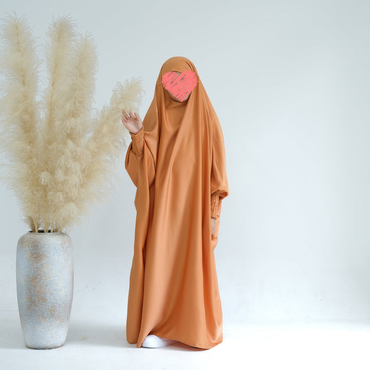 Get trendy with Marwa Kids Satin Jilbab - Sandstone - Dresses available at Voilee NY. Grab yours for $39.90 today!