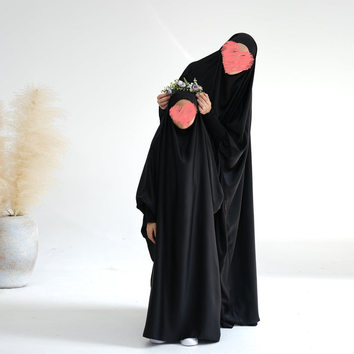 Get trendy with Marwa Kids Satin Jilbab - Black - Dresses available at Voilee NY. Grab yours for $39.90 today!