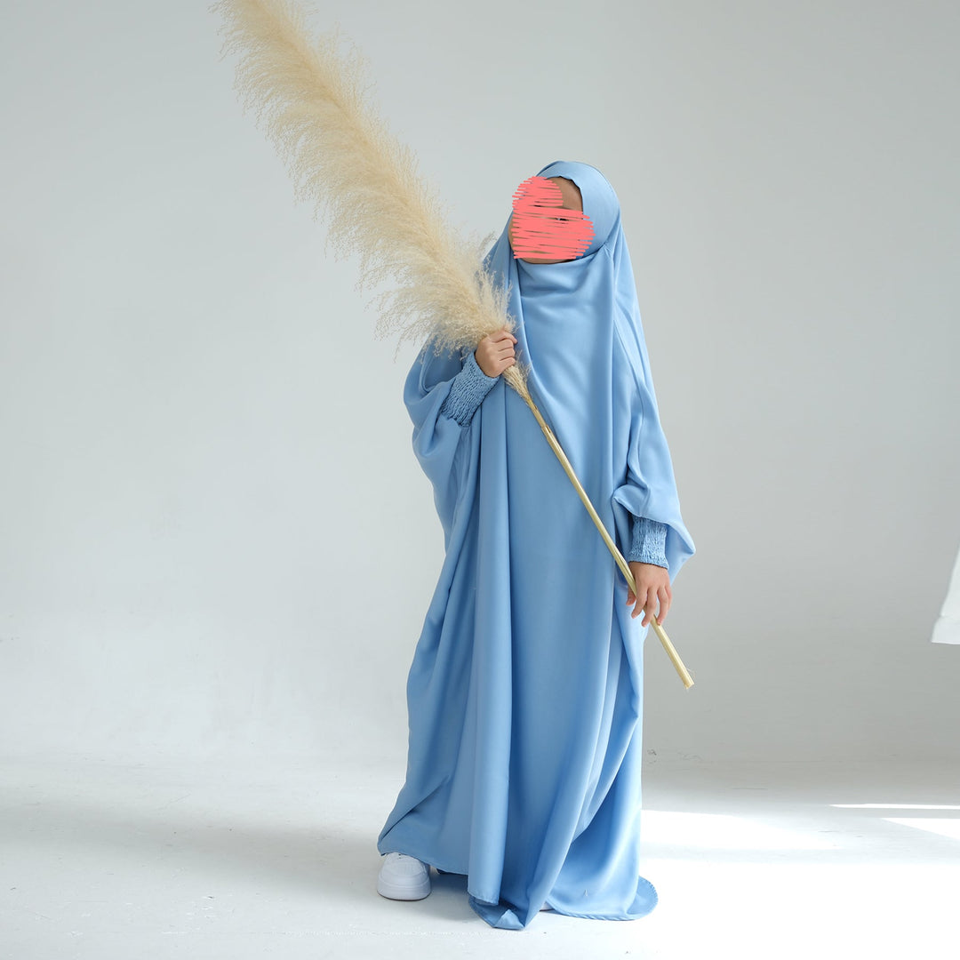 Get trendy with Marwa Kids Satin Jilbab - Blue - Dresses available at Voilee NY. Grab yours for $39.90 today!