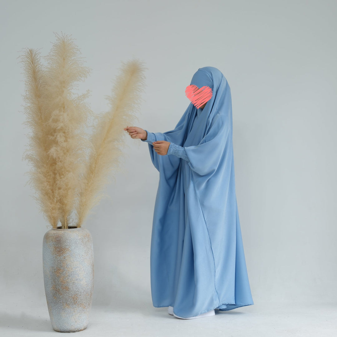 Get trendy with Marwa Kids Satin Jilbab - Blue - Dresses available at Voilee NY. Grab yours for $39.90 today!