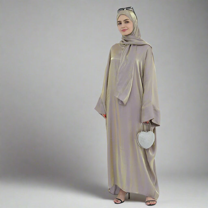 Get trendy with Nessa Shimmer Abaya with Hijab - Beige - Dresses available at Voilee NY. Grab yours for $54.90 today!