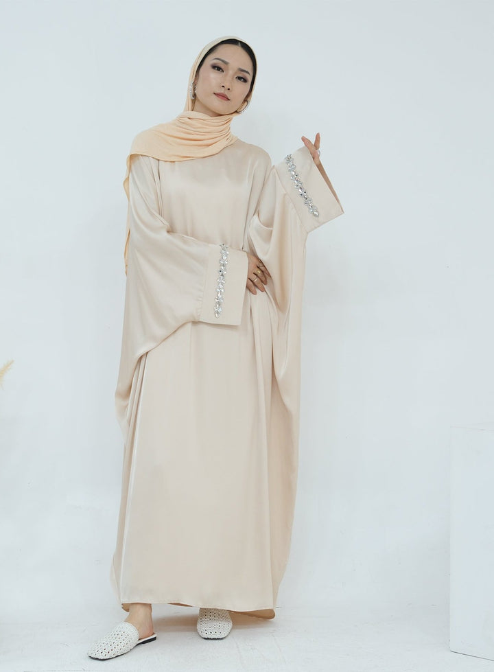 Get trendy with Delisa Butterfly Satin Abaya - Beige -  available at Voilee NY. Grab yours for $74.90 today!