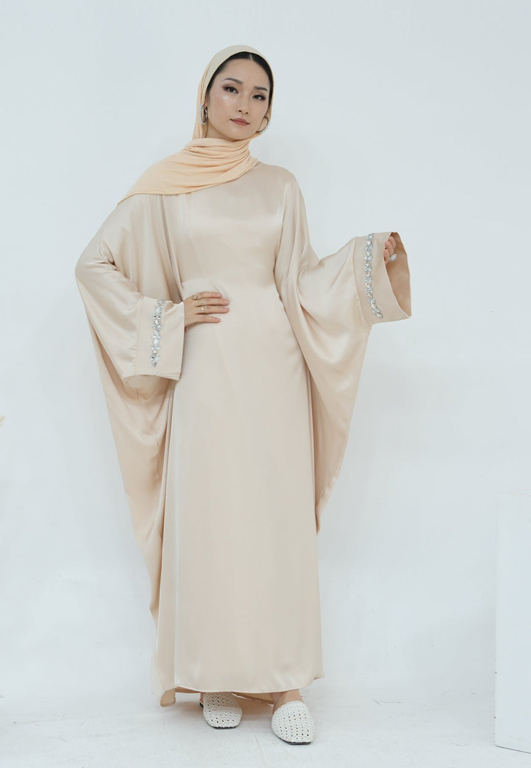 Get trendy with Delisa Butterfly Satin Abaya - Beige -  available at Voilee NY. Grab yours for $74.90 today!