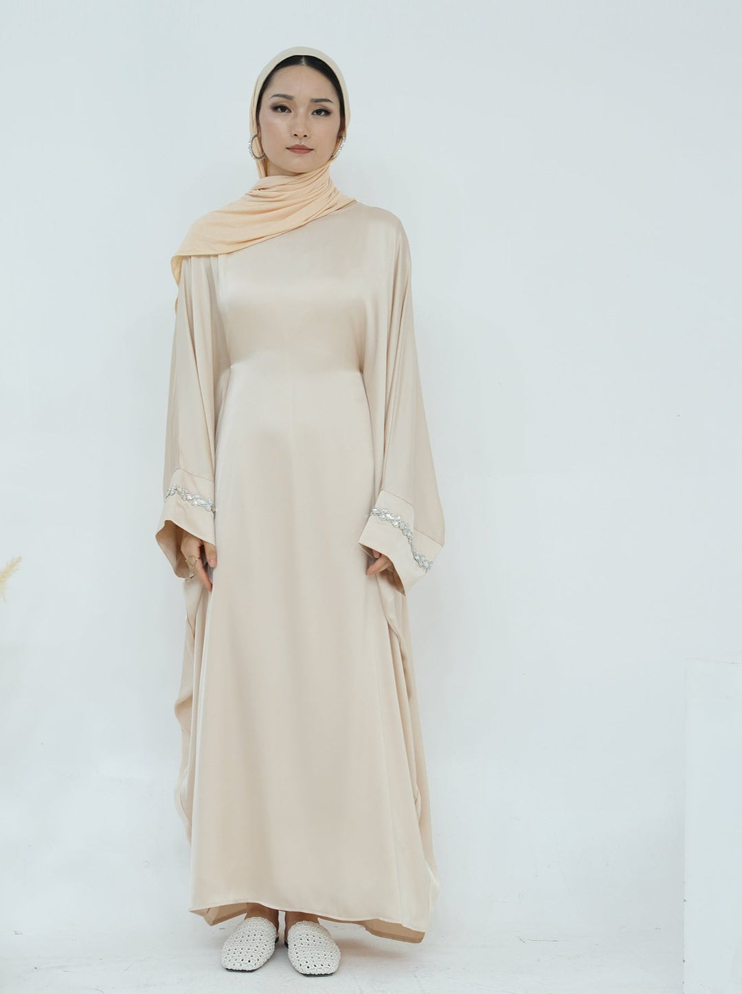 Get trendy with Delisa Butterfly Satin Abaya - Beige -  available at Voilee NY. Grab yours for $74.90 today!