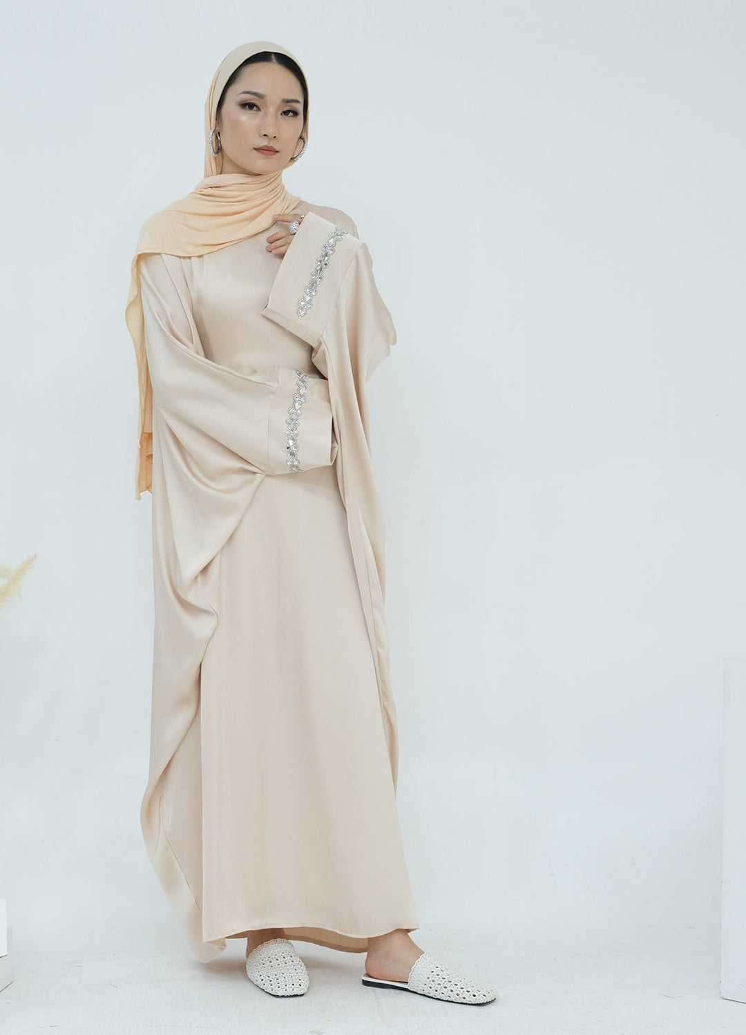 Get trendy with Delisa Butterfly Satin Abaya - Beige -  available at Voilee NY. Grab yours for $74.90 today!