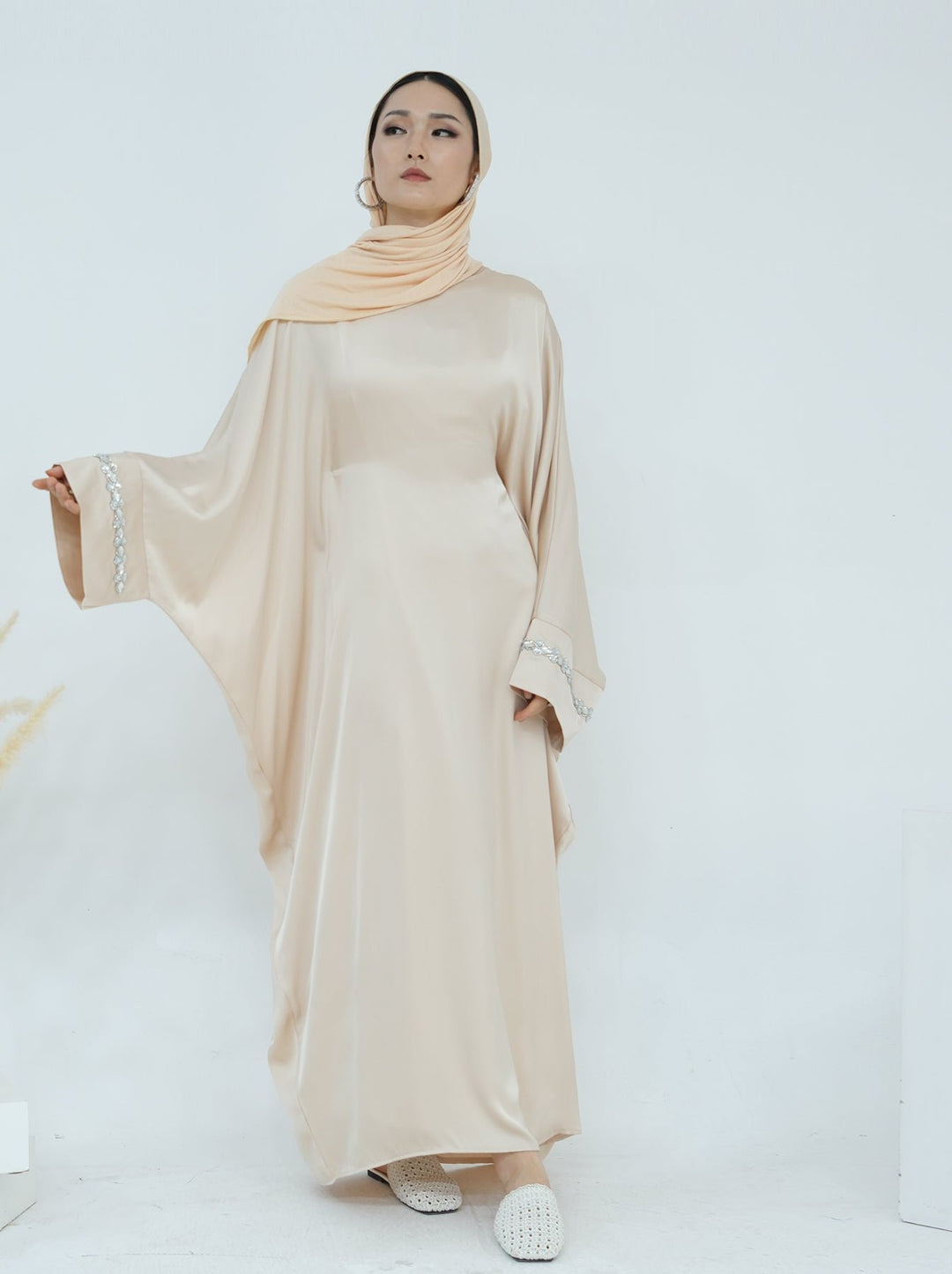 Get trendy with Delisa Butterfly Satin Abaya - Beige -  available at Voilee NY. Grab yours for $74.90 today!