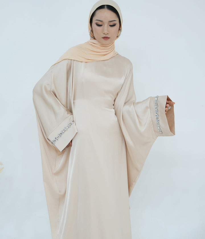 Get trendy with Delisa Butterfly Satin Abaya - Beige -  available at Voilee NY. Grab yours for $74.90 today!