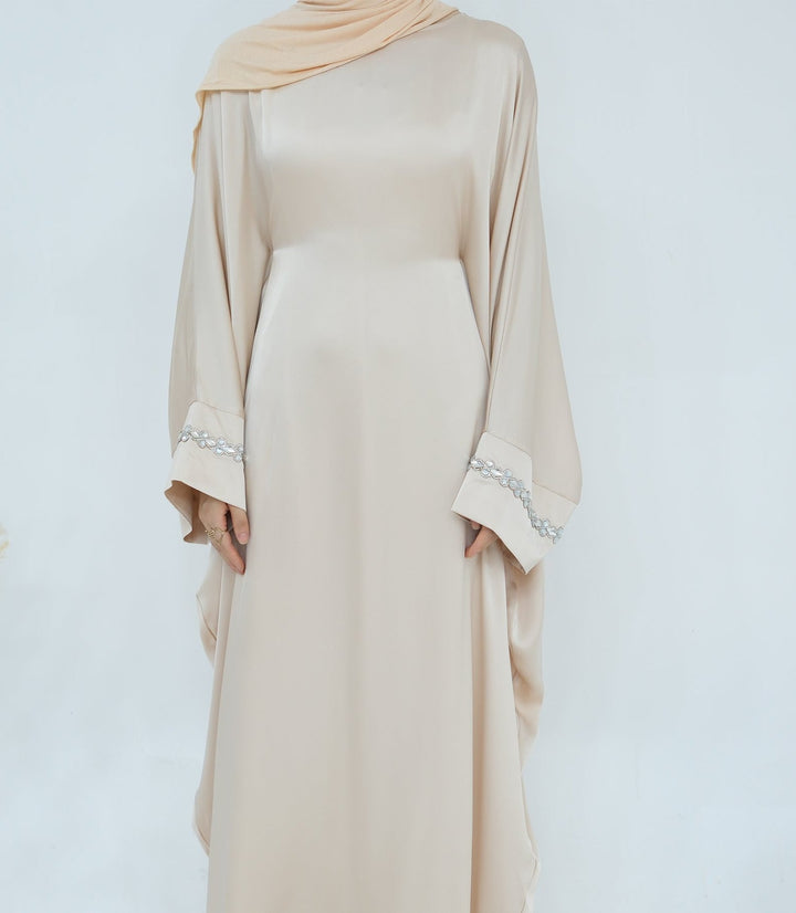 Get trendy with Delisa Butterfly Satin Abaya - Beige -  available at Voilee NY. Grab yours for $74.90 today!