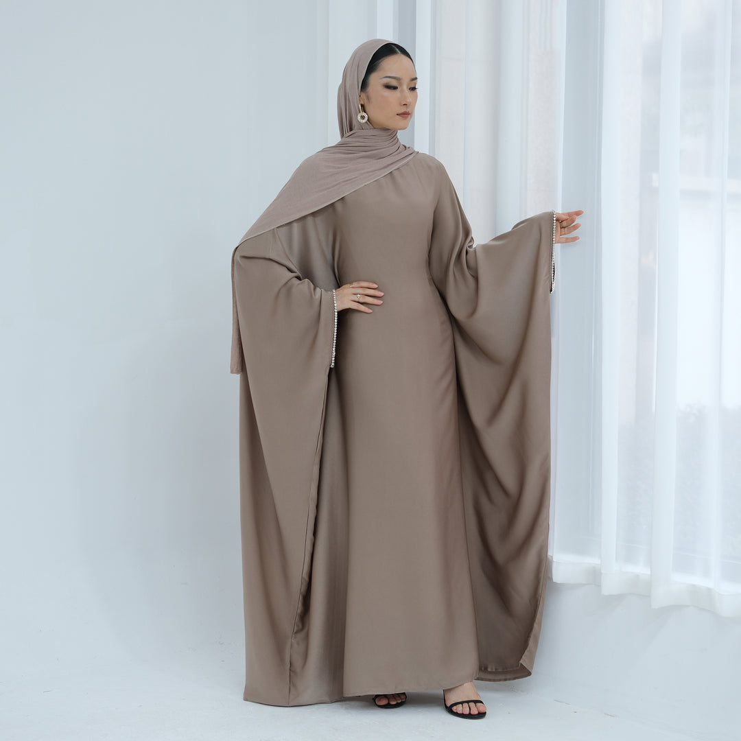 Get trendy with Davina Butterfly Satin Abaya - Taupe -  available at Voilee NY. Grab yours for $69.90 today!