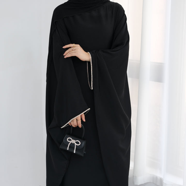 Get trendy with Davina Butterfly Satin Abaya - Black -  available at Voilee NY. Grab yours for $69.90 today!