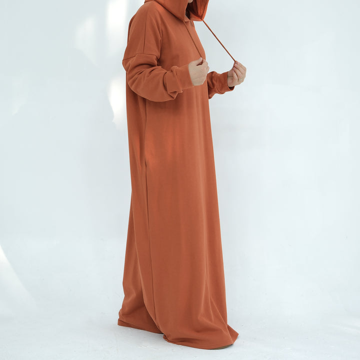 Get trendy with Alora Cotton Hoodie Abaya - Rust -  available at Voilee NY. Grab yours for $59.90 today!