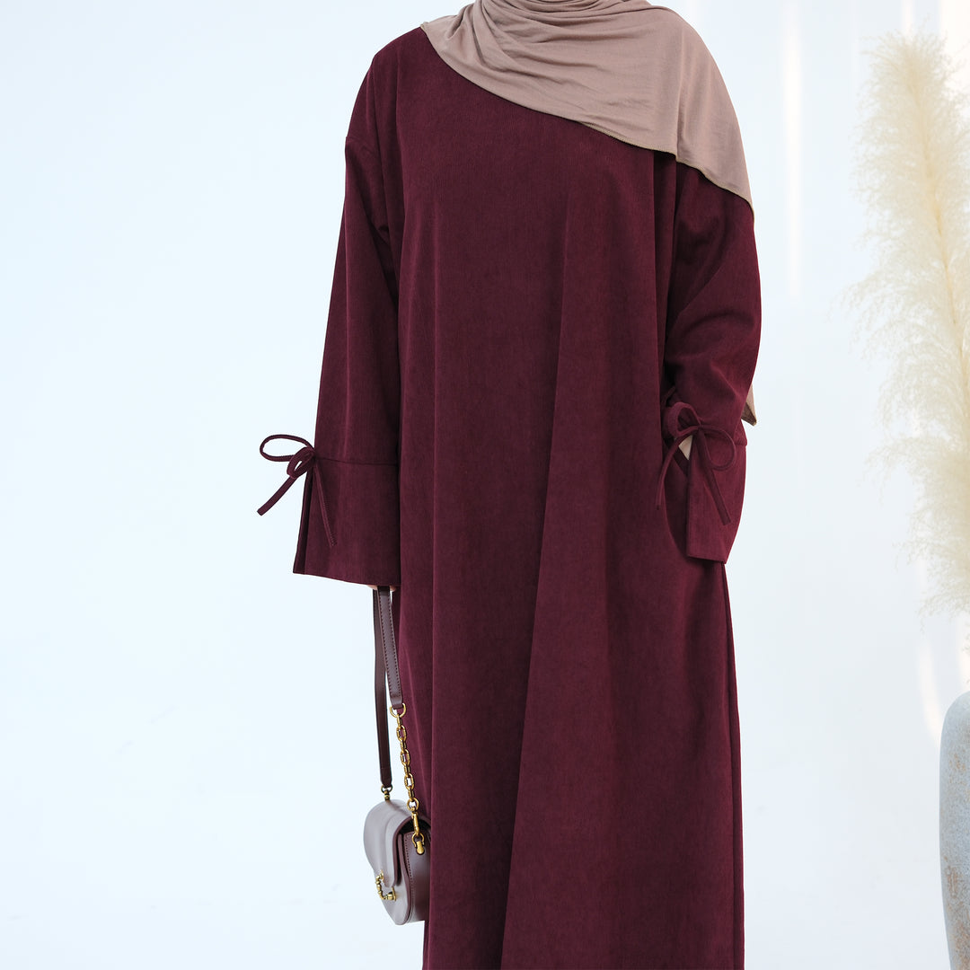 Get trendy with Tara Corduroy Abaya Dress - Wine - Dresses available at Voilee NY. Grab yours for $62.90 today!