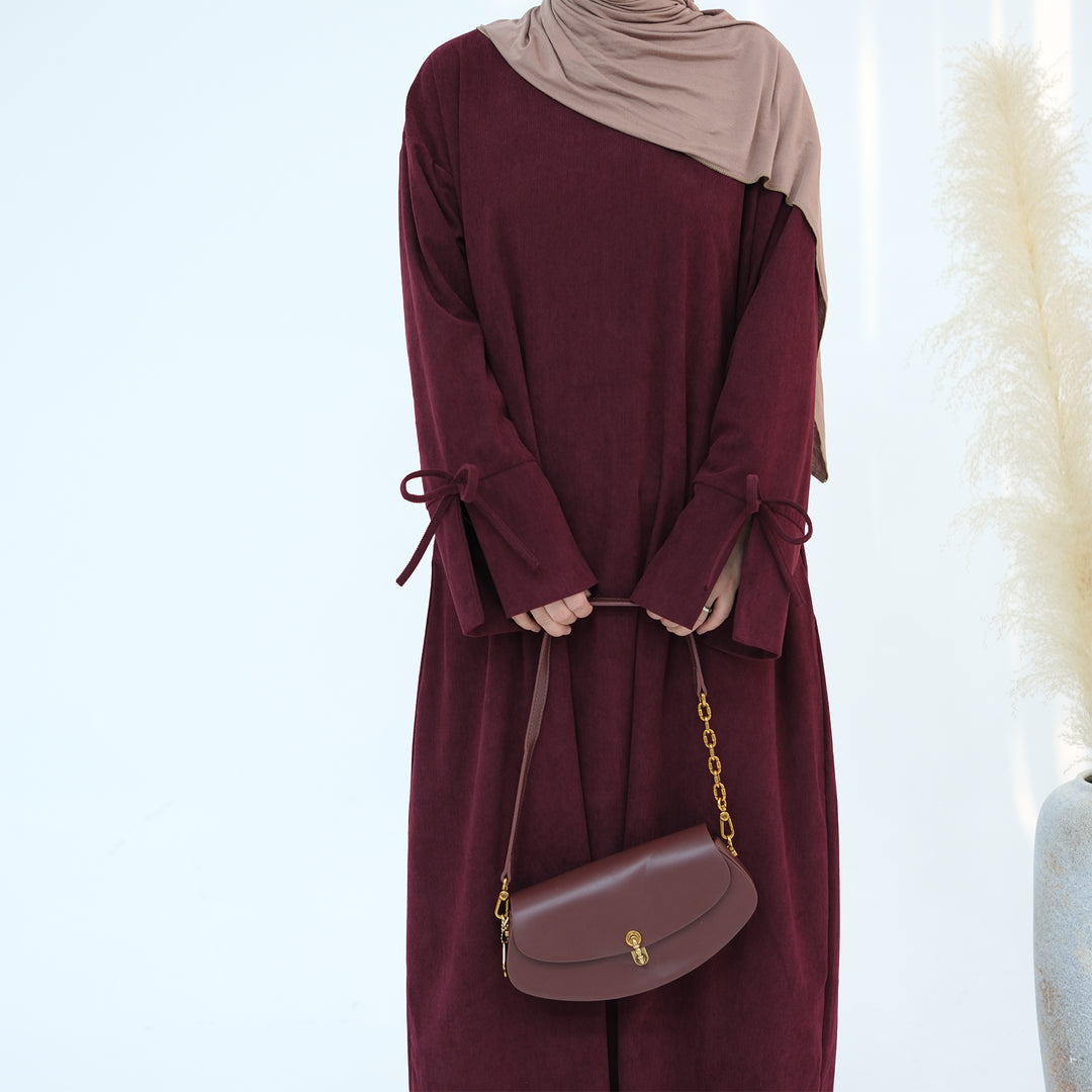 Get trendy with Tara Corduroy Abaya Dress - Wine - Dresses available at Voilee NY. Grab yours for $62.90 today!