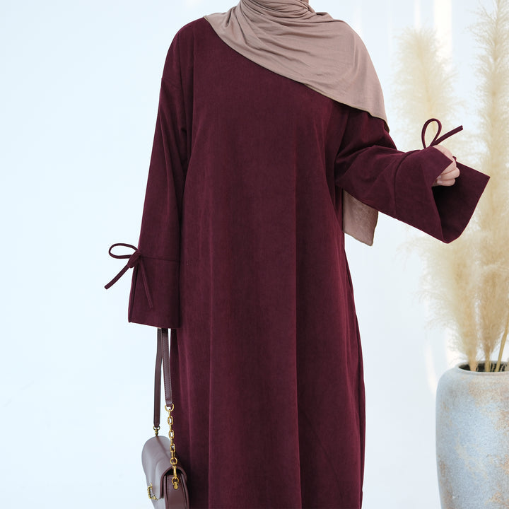 Get trendy with Tara Corduroy Abaya Dress - Wine - Dresses available at Voilee NY. Grab yours for $62.90 today!