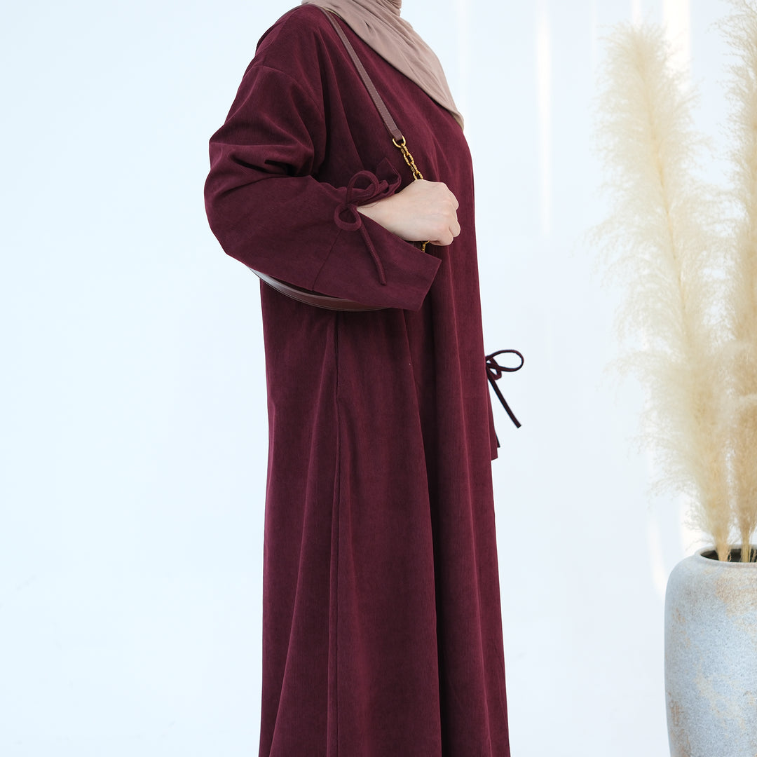 Get trendy with Tara Corduroy Abaya Dress - Wine - Dresses available at Voilee NY. Grab yours for $62.90 today!