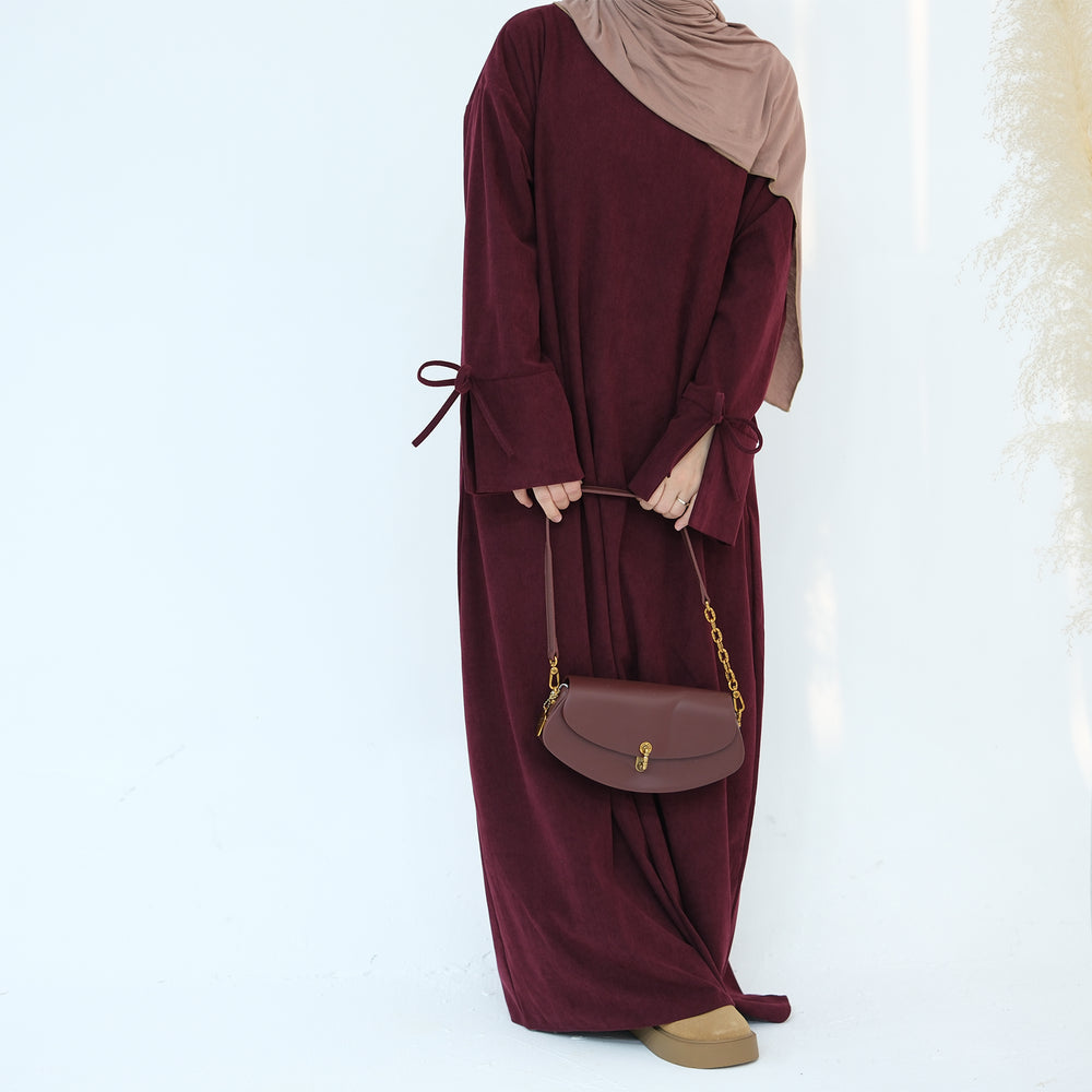 Get trendy with Tara Corduroy Abaya Dress - Wine - Dresses available at Voilee NY. Grab yours for $62.90 today!