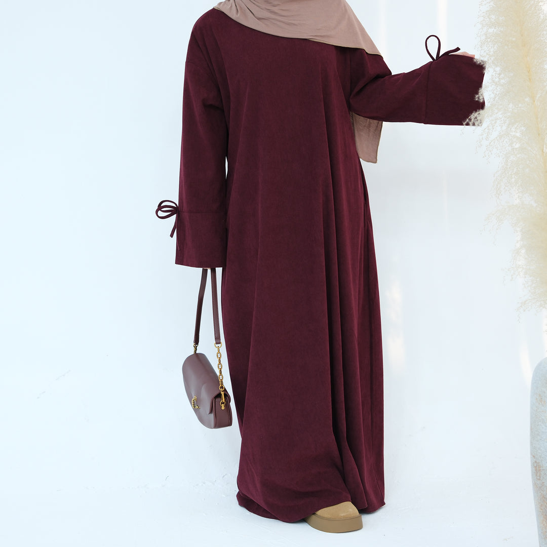 Get trendy with Tara Corduroy Abaya Dress - Wine - Dresses available at Voilee NY. Grab yours for $62.90 today!