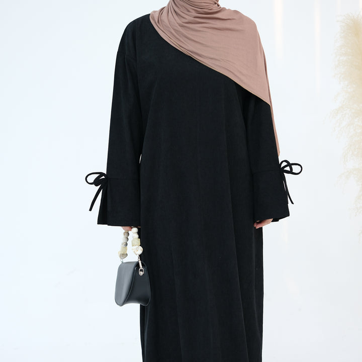 Get trendy with Tara Corduroy Abaya Dress - Black - Dresses available at Voilee NY. Grab yours for $62.90 today!