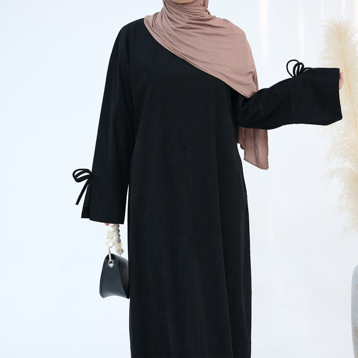 Get trendy with Tara Corduroy Abaya Dress - Black - Dresses available at Voilee NY. Grab yours for $62.90 today!