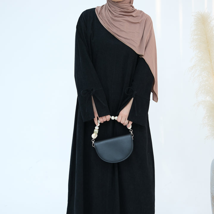 Get trendy with Tara Corduroy Abaya Dress - Black - Dresses available at Voilee NY. Grab yours for $62.90 today!