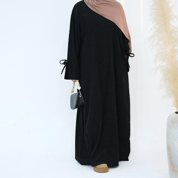 Get trendy with Tara Corduroy Abaya Dress - Black - Dresses available at Voilee NY. Grab yours for $62.90 today!