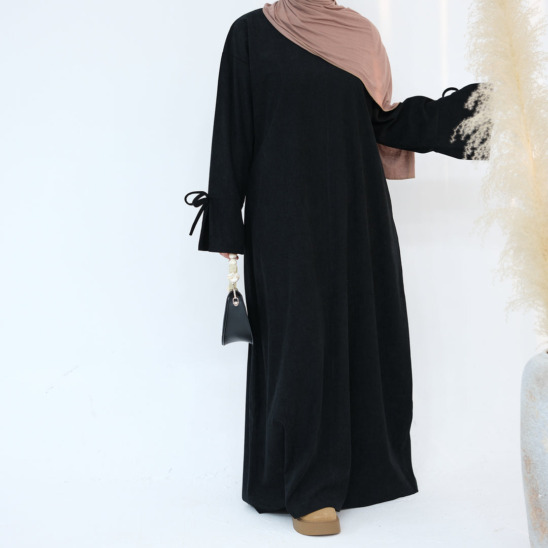 Get trendy with Tara Corduroy Abaya Dress - Black - Dresses available at Voilee NY. Grab yours for $62.90 today!