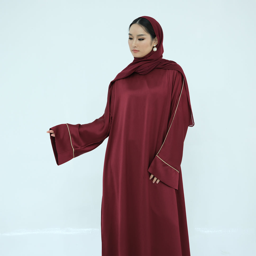 Get trendy with Ayana Textured Piping Detail Abaya - Red - Dresses available at Voilee NY. Grab yours for $49.90 today!