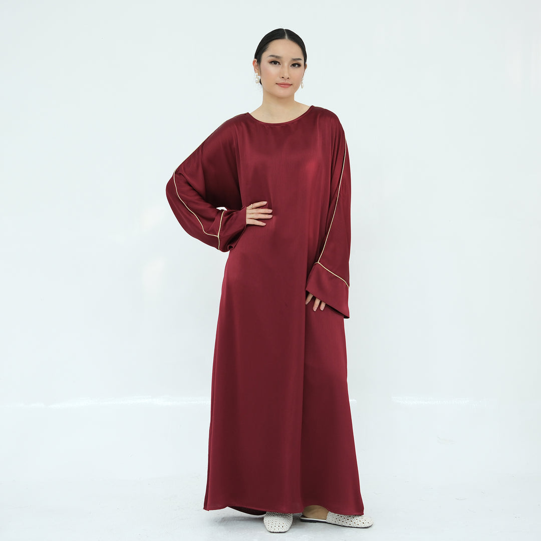 Get trendy with Ayana Textured Piping Detail Abaya - Red - Dresses available at Voilee NY. Grab yours for $49.90 today!