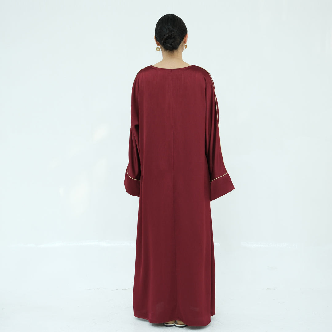 Get trendy with Ayana Textured Piping Detail Abaya - Red - Dresses available at Voilee NY. Grab yours for $49.90 today!