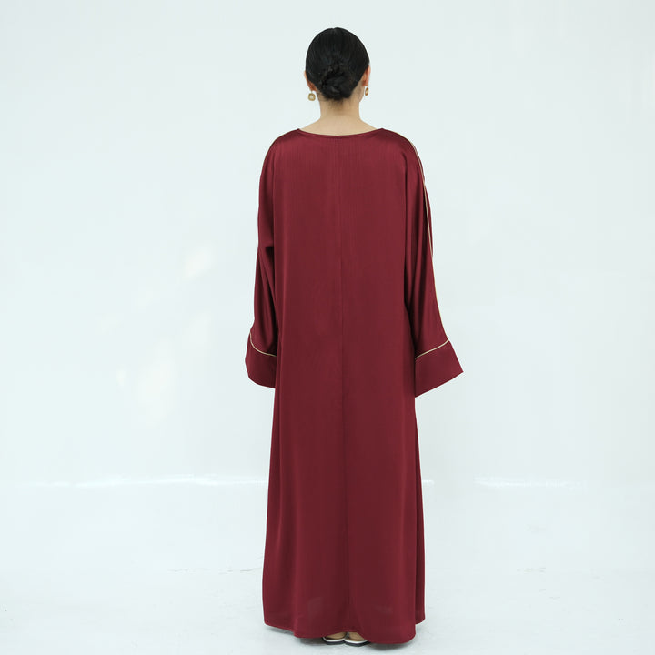 Get trendy with Ayana Textured Piping Detail Abaya - Red - Dresses available at Voilee NY. Grab yours for $49.90 today!