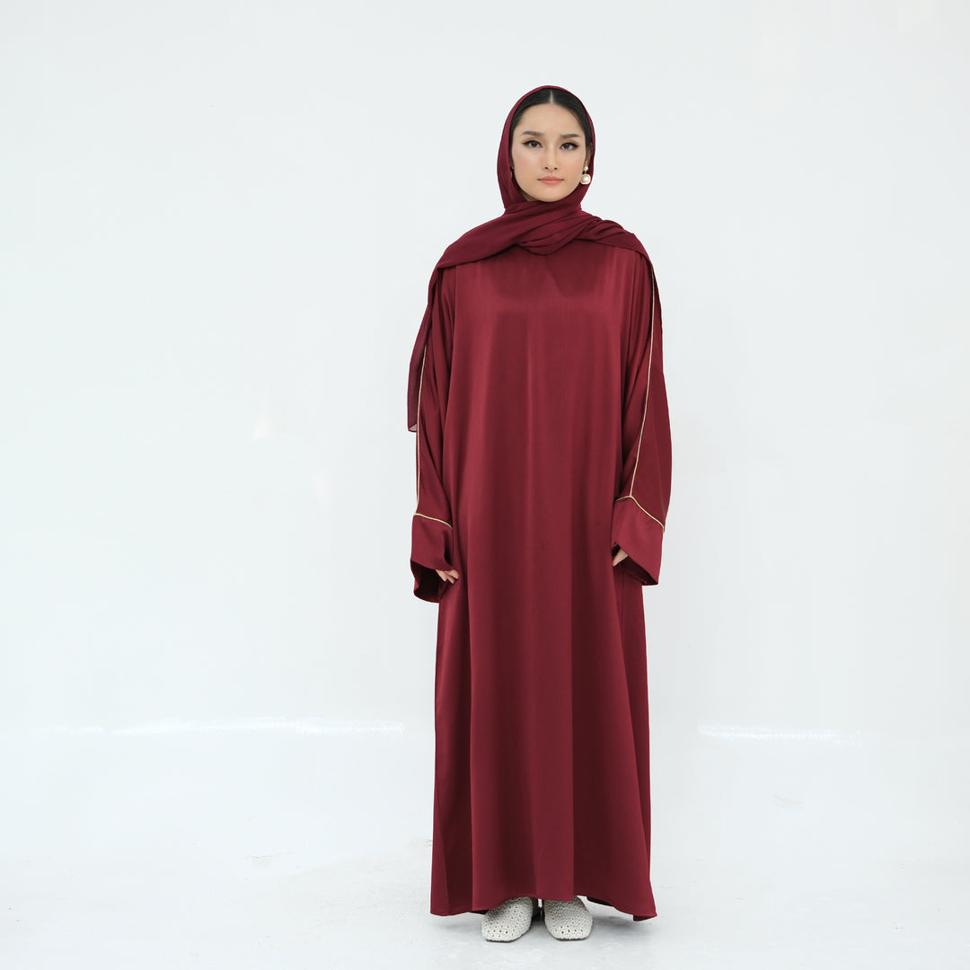 Get trendy with Ayana Textured Piping Detail Abaya - Red - Dresses available at Voilee NY. Grab yours for $49.90 today!