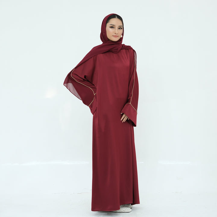 Get trendy with Ayana Textured Piping Detail Abaya - Red - Dresses available at Voilee NY. Grab yours for $49.90 today!