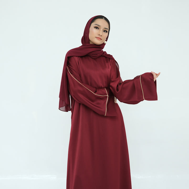 Get trendy with Ayana Textured Piping Detail Abaya - Red - Dresses available at Voilee NY. Grab yours for $49.90 today!