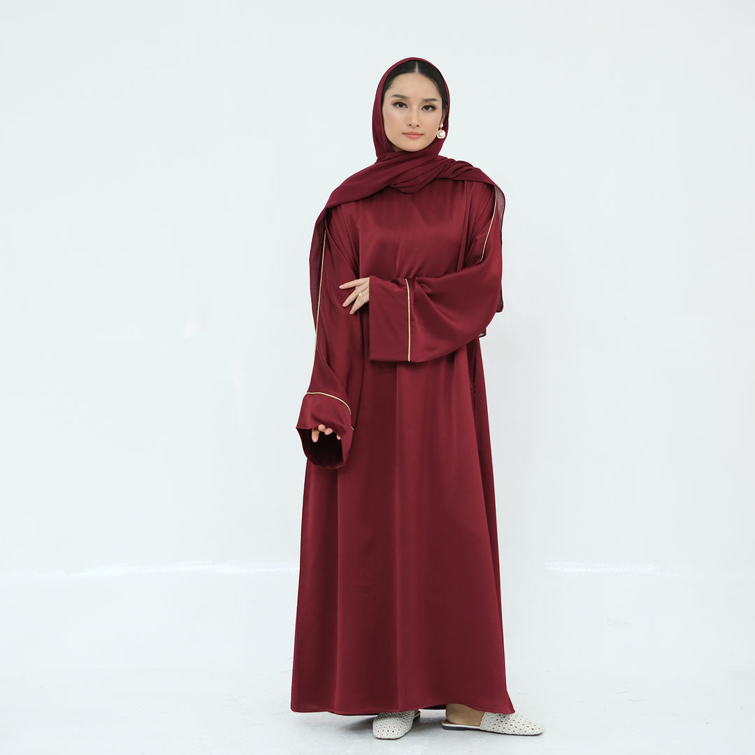 Get trendy with Ayana Textured Piping Detail Abaya - Red - Dresses available at Voilee NY. Grab yours for $49.90 today!